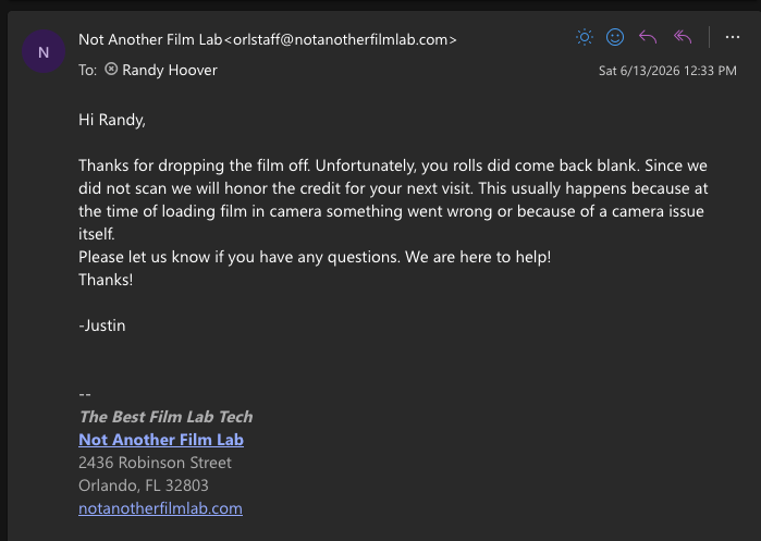 creenshot of an email notification in a dark mode interface. The email is from "Not Another Film Lab" to Randy Hoover, informing him that his rolls of film came back blank and that they will honor a credit for his next visit.